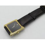 Jaeger Lecoultre hand wound wrist watch. 18K gold case on leather strap, case back stamped 18K, .750