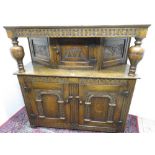 Good quality reproduction oak court cupboard, carved with lunettes and scrolls, with three panel
