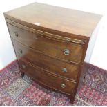 19th C mahogany bow front bachelors chest, with brushing slide above three long cock-beaded