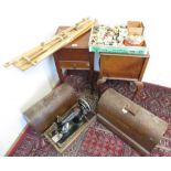 Two singer hand sewing machines in dome top cases, two sewing boxes, an embroidery frame, and a