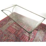 Modern coffee table, with inset bevelled edge plate glass top on scrolled metal supports. (116cm x