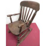 Child's stained beech Windsor type rocking chair with stick back and turned supports on curved