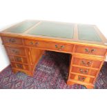 Geo. lll style yew twin pedestal desk with inset gilt tooled leather top on bracket feet. (W137cm