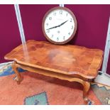 Walnut coffee table with a shaped rectangular top and single end drawer on cabriole legs. (L105cm