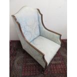 Edwardian inlaid mahogany framed wing back armchair on square tapered supports with brass sockets