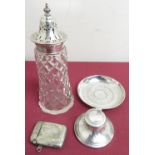 Small hallmarked silver capstan ink well, a cut glass sugar sifter with silver top, an Indo-