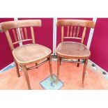 Pair of bentwood cafe chairs with curved slat backs and solid seats on splayed feet. (2)