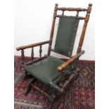 Late 19th C child's turned beech American rocking chair with brass nail upholstered seat and back (