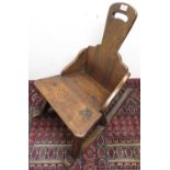 Late 19th C country made oak rocking chair with paddle back and tapering seat on square supports