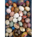 Collection of polished hardstone eggs and painted wooden eggs