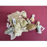 Three late 19th C pincushion dolls, a porcelain model of a ballet dancer and a doll dress