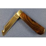 Single bladed gutting pocket knife with two piece polished wood grips