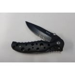 Boxed as new Whitby Knives folding knife with 3 inch black blade and black pierced handle