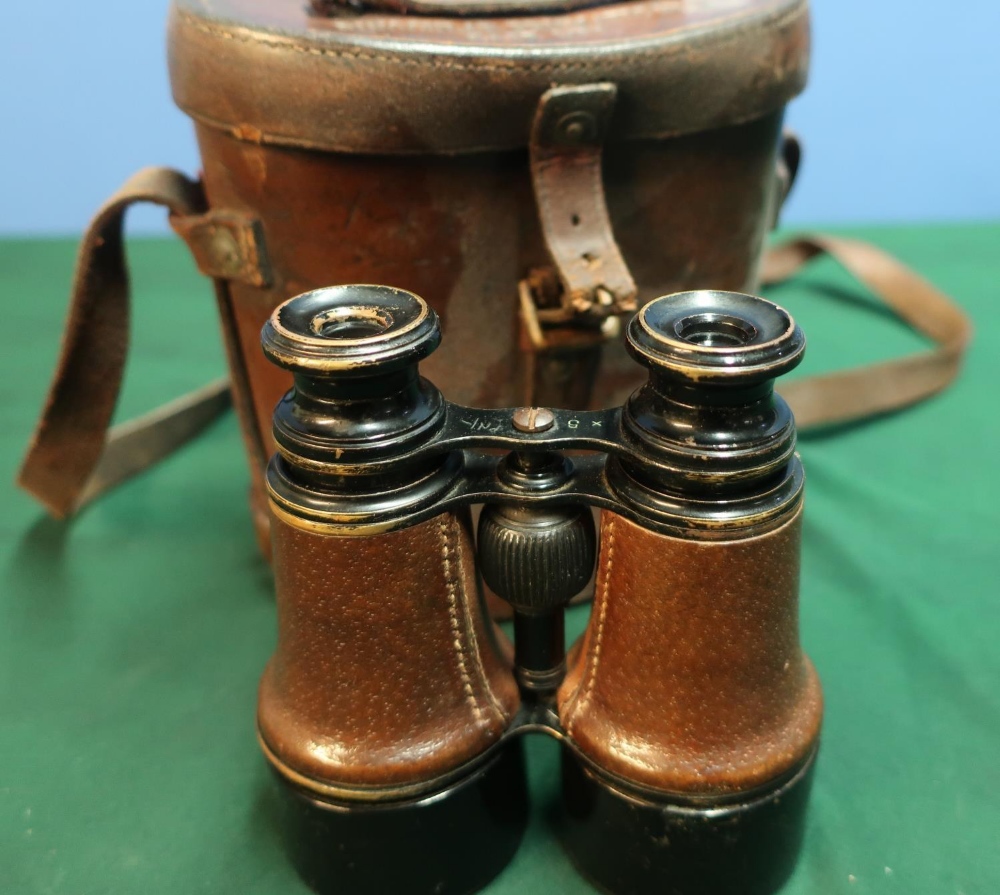 Cased pair of leather bound binoculars the case marked with binocular prismatic No6 case Mk1 with