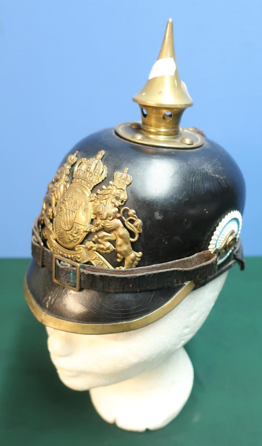 WWI Prussian leather bodied pickelhaube helmet with raised brass spike and central crest badge