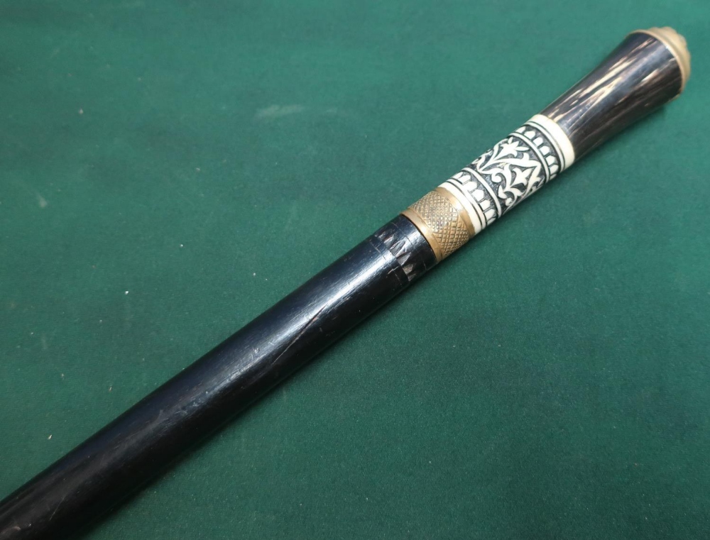 Early 20th C Indian ebonised swagger type cane with carved horn and bone grip and lions head pommel,