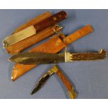 Bowie type sheath knife with 5 1/2 inch blade and two piece antler grips with tan leather rearing