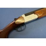 Century 12B over and under shotgun, with 28 inch barrels, 14 1/4 inch pistol grip stock, serial