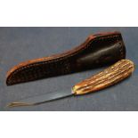 Cock Fighter sheath knife with 3 1/2 inch narrow blade, antler grip and tooled leather sheath