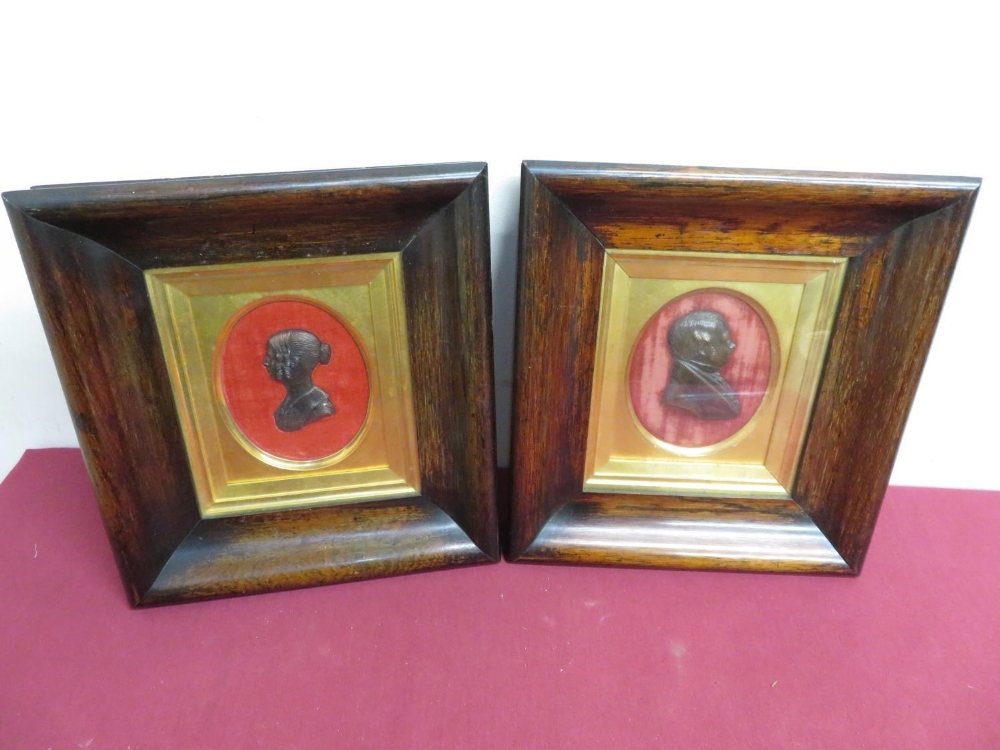 A pair of 19th C mahogany framed cast bronze silhouette portraits of a lady and gentleman, in gilt