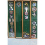 Four framed and mounted wall displays of various phantom cloth air force badges