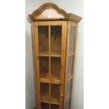 Pine corner glazed display cabinet with four shelves above a drawer enclosed by a single door