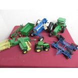 Large scale Ertl diecast model of a blue Ford 8600 tractor harrow, a smaller Ertl green tractor with