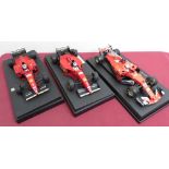 Burago 1:18 scale model of a Ferrari driven by Sebastian Vettel, and two Ferrari's driven by Michael