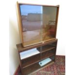 Oak low bookcase enclosed by a pair of sliding glazed doors (W92cm x D23cm x H74cm), a teak bookcase