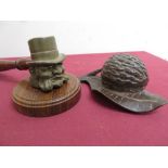 Unusual metal gavel cast as an elderly gentleman with turned wooden handle, L20cm and a Black Forest
