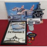 Framed and mounted Mcdonnell Douglas F4 Phantom mirror, two Phantom desk figures, lapel badges,