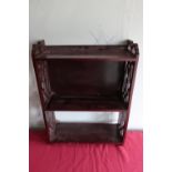 Edwardian mahogany three tier wall shelf with fretwork sides, W41.5cm D15cm H55cm