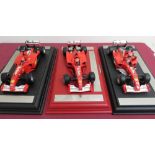 Hot Wheels 1:18 scale model Ferrari's Michael Schumacher World Champion 2000, 2001, 2002, on plinths