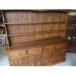 Cryer Craft elm dresser with twin shelf back above four drawers and four four-panelled doors on