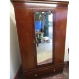Edwardian inlaid mahogany wardrobe with single mirror door above a single long drawer. (W129cm x
