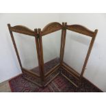 Edwardian oak framed two-fold screen, three glazed panels with carved cresting on turned supports