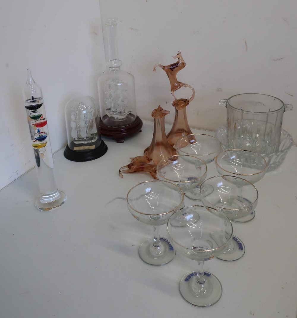 Galileo thermometer in box, glass model of a three masted ship in a bottle, another under dome,
