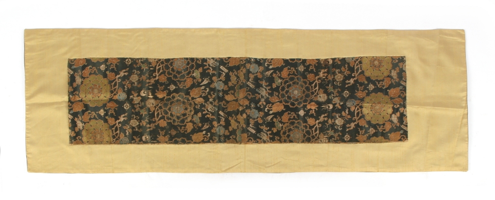 An 18th century Chinese zhijin embroidered silk panel depicting flowers, the panel approximately