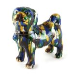 A Chinese 'egg and spinach' glazed model of a standing dog, with blue & brown splashes, 6.75ins. (