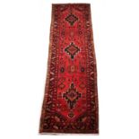 Property of a gentleman - a Turkish woollen hand-made runner with red ground, 118 by 35ins. (300