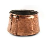 Property of a gentleman - a copper log bin with bale handles, 22ins. (56cms.) diameter (overall).