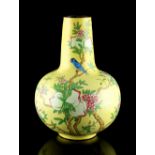 Property of a lady - a Chinese Canton enamel yellow ground bottle vase, decorated with birds among
