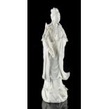 A Chinese blanc de Chine figure of Guanyin, 20th century, modelled standing & holding a lotus