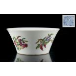 A Chinese famille rose flaring bowl, painted with peaches & a pomegranate, the interior painted with