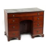 Property of a gentleman - an early George IV mahogany kneehole desk, with green leather inset top