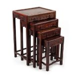 Property of a deceased estate - a nest of four Chinese carved hongmu occasional tables, the