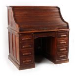 Property of a gentleman - an early 20th century oak twin pedestal 'S'-shaped roll-top desk, with