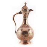 An Islamic copper lidded ewer, 19th century or earlier, 10.75ins. (27.5cms.) high.