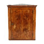 Property of a gentleman - an early 18th century walnut & featherbanded corner wall cabinet, the