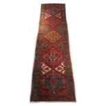 Property of a gentleman - a Turkish woollen hand-made runner with red ground, 174 by 46ins. (442